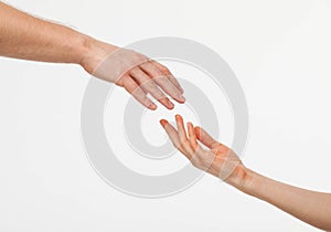 Hands of man and woman reaching out to each other photo