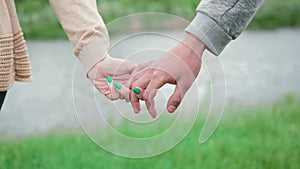 Hands of man and woman reaching to each other. Soft, gentle touch of hands on background of nature. Be hand in hand