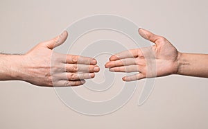 Hands man and woman reaching to each other, support. Giving a helping hand. Hands of man and woman on gray background