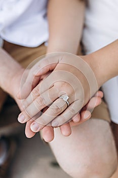 Hands of a man and woman with a wedding ring close-up