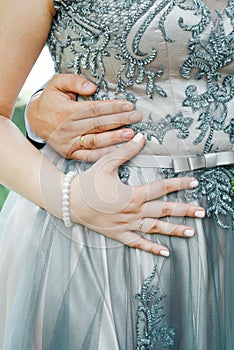 Hands of man and woman with wedding rings. Gold rings on the hands of the newlyweds
