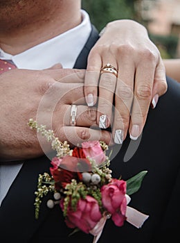 hands of man and woman with wedding rings. Gold rings on the hands of the newlyweds