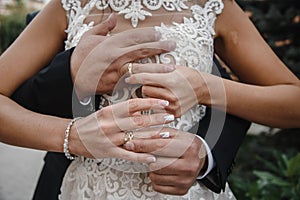 hands of man and woman with wedding rings. Gold rings on the hands of the newlyweds