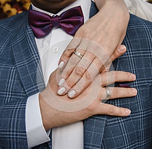 hands of man and woman with wedding rings. Gold rings on the hands of the newlyweds