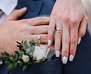 hands of man and woman with wedding rings. Gold rings on the hands of the newlyweds