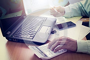 Hands of a man working on office desk in shinning light