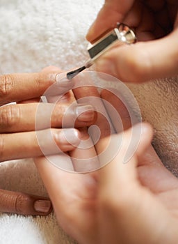 Hands, manicure and nail polish in salon, top view and beauty treatment process to relax. Closeup, spa and painting