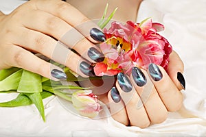 Hands with manicured nails with cat eye design