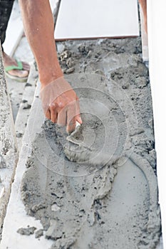 Hands of manual worker with plastering tools renovating house. Construction works