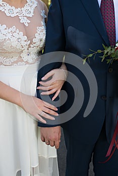 Hands of married couple with rings.