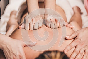 4 hands massage - two masseurs work simultaneously on the patient back