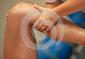 Hands massaging athlete's thigh after running