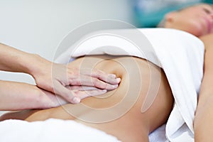Hands massaging female abdomen.Therapist applying pressure on be
