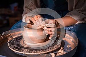The hands of the master who makes the jug. Close-up. photo