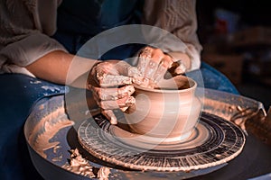 The hands of the master who makes the jug. Close-up. photo