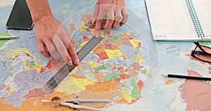 Hands measuring distance on world map with ruler closeup 4k movie slow motion