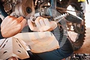 Hands, mechanic and engine gear repairs working on motor with tools for safety or mechanical parts. Hand of engineer