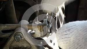 Hands of mechanic using fix wrench to tighten and loosen hex bolt of car engine start motor