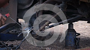 Hands of mechanic welding for repair the truck wishbone control arm of front wheel