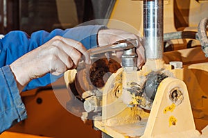 Hands of mechanic working in auto repair shop.