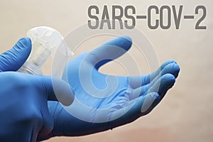 Hands medical gloves spray alcohol antiseptic - coronavirus,, lettering sars-cov-2