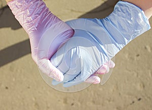 Hands in medical gloves on the street. photo