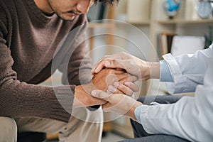 Hands of medical personnel comforting to reassure the patient in clinic