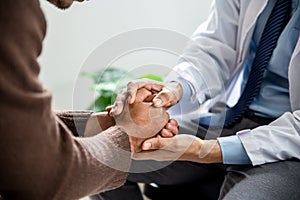 Hands of medical personnel comforting to reassure the patient in clinic