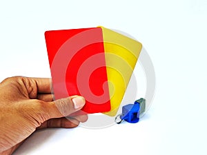 The hands of men brandishing red cards and yellow cards on a white background