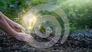 Hands of men touching leaf and glowing light bulb on the soil. Symbol. Against nature on green leaf background with icons energy