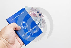 Hands of middle-aged man holding work book, Brazilian social security document