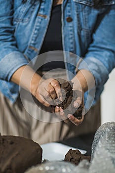 Hands molding clay in a clay workshop to teach people how to mold the material to create figures