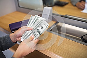 Hands with money at bank or currency exchanger