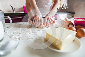 Hands Of Mother And Daughter Knead Dough For Pizza