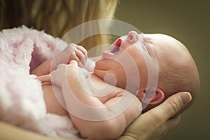 Hands of Mother Holding Her Newborn Baby Girl