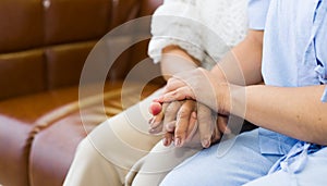 Hands of mother reassuring her daughter while sick