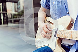 Hands of musician with guitar