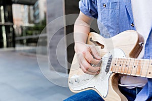 Hands of musician with guitar