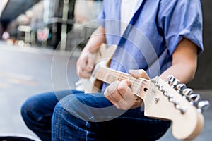 Hands of musician with guitar