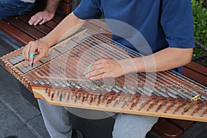 hands of musician playing on cimbalom or dulcimer,