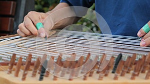 hands of musician playing on cimbalom or dulcimer,