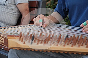 hands of musician playing on cimbalom or dulcimer, photo