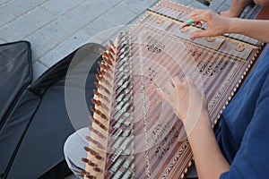 hands of musician playing on cimbalom or dulcimer, photo