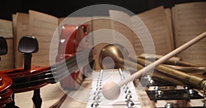 The hands of a musician playing cymbals. Musical instruments with sheet music on table