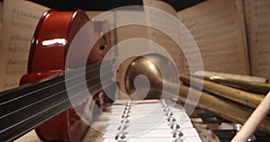 The hands of a musician playing cymbals. Musical instruments with sheet music on table