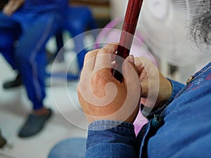 Hands of a musician playing Khlui, Thai flute: vertical duct flute made of bamboo, hardwood, or plastic