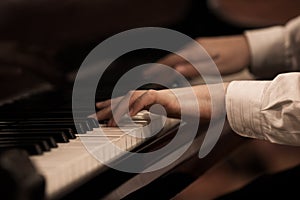 The hands of a musician playing the piano