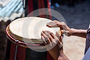 Hands of a musician standing still on a Brazilian atabaque