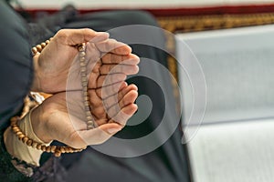 Hands of muslim prayer woman with rosary in dua praying for allah blessing