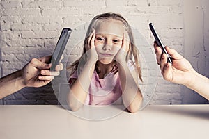 Hands of network addict parents using mobile phone neglecting little sad ignored daughter bored